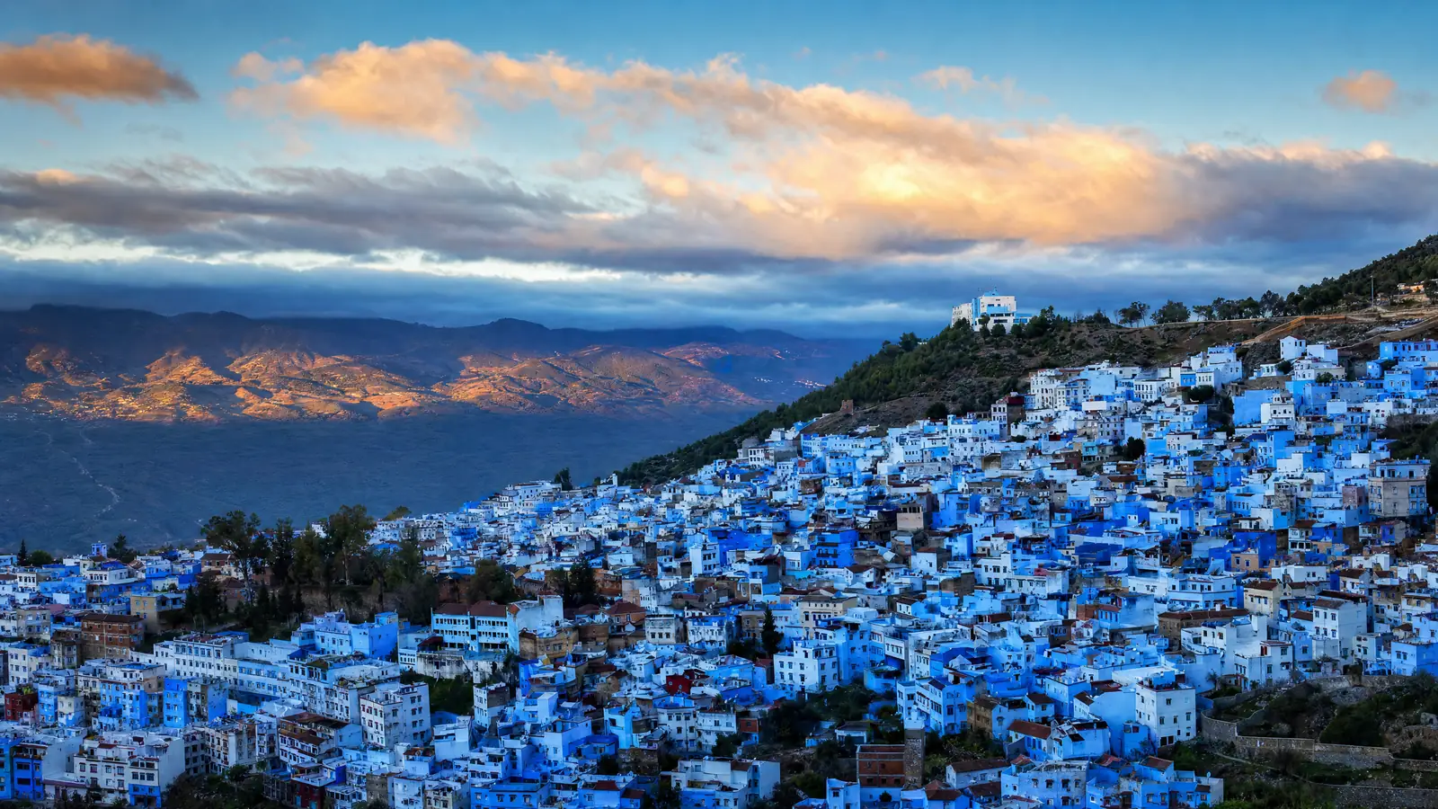 Chefchaouen's blue houses on the Rif mountainside at sunset