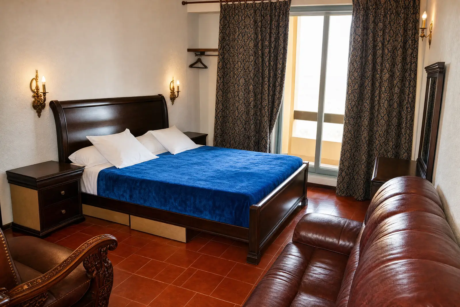 A double bedroom with a blue bedspread at Hôtel Rose Mgouna